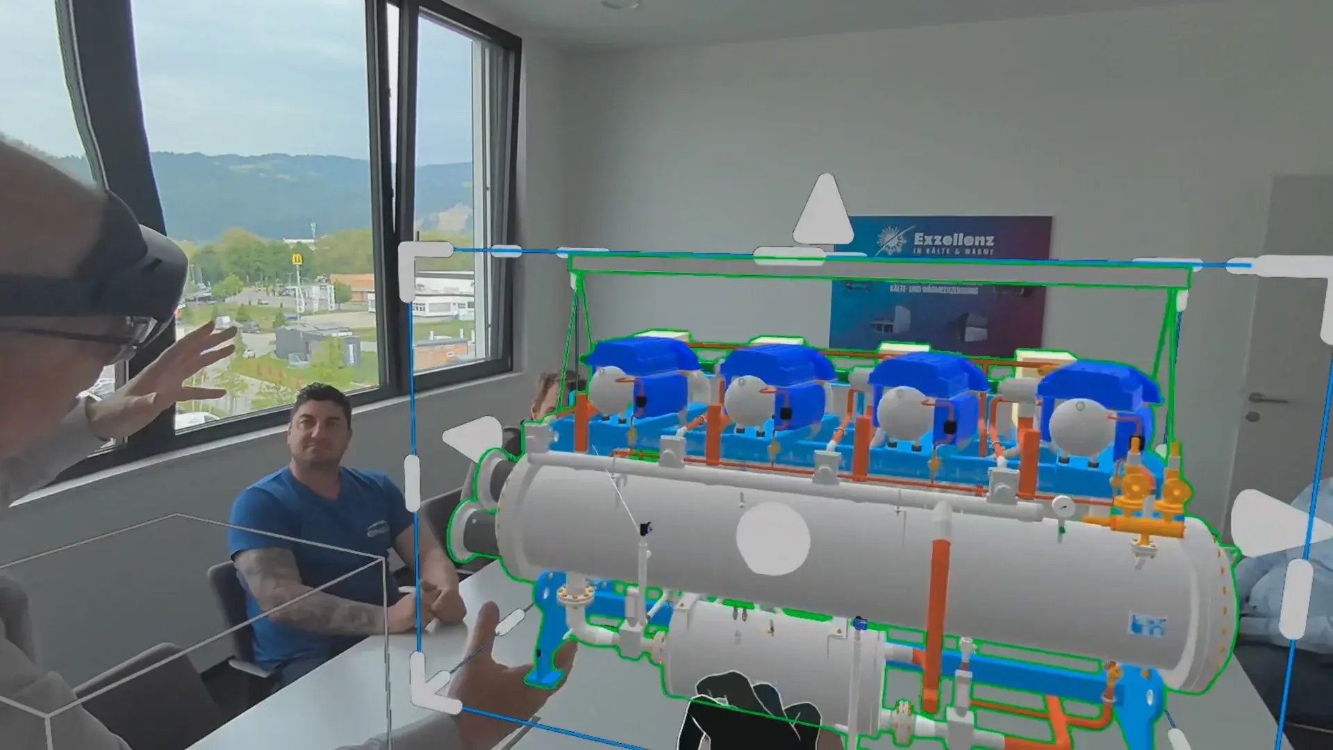 A team reviews a digital twin of a machine in AR as part of handover to production.