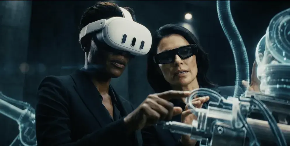 Two engineers wearing the Meta Quest 3 and Snap Spectacles inspecting a car assembly line.